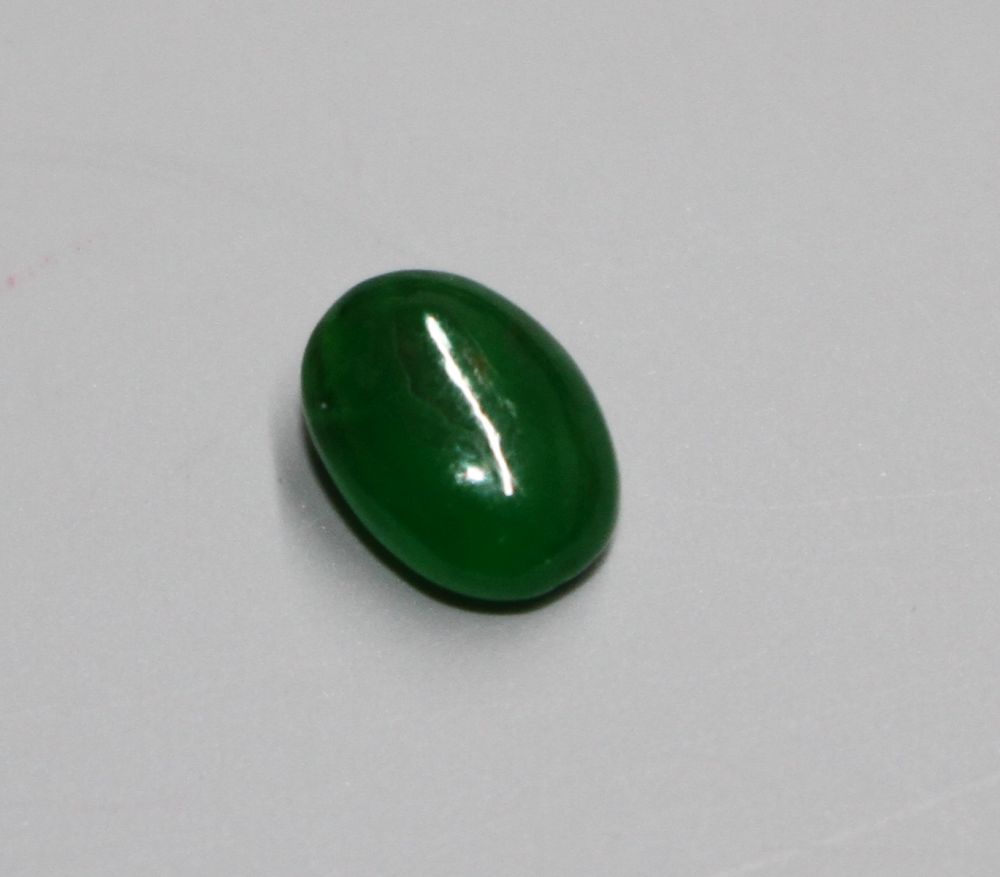 An unmounted cabochon cut jadeite stone, with GCS certificate dated 25/02/20